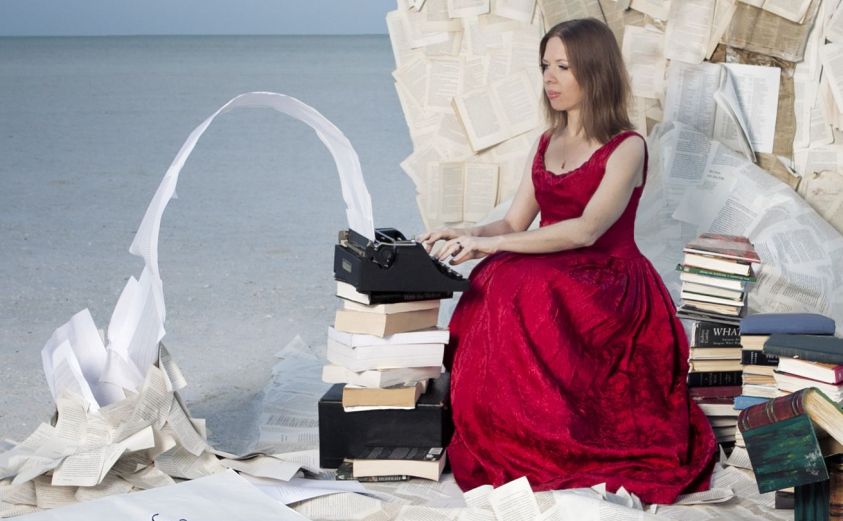  Faith typing on a typwriter, words pouring into books 