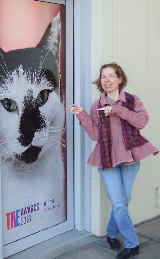  Faith Harkey with a cat mural at the University of Essex 